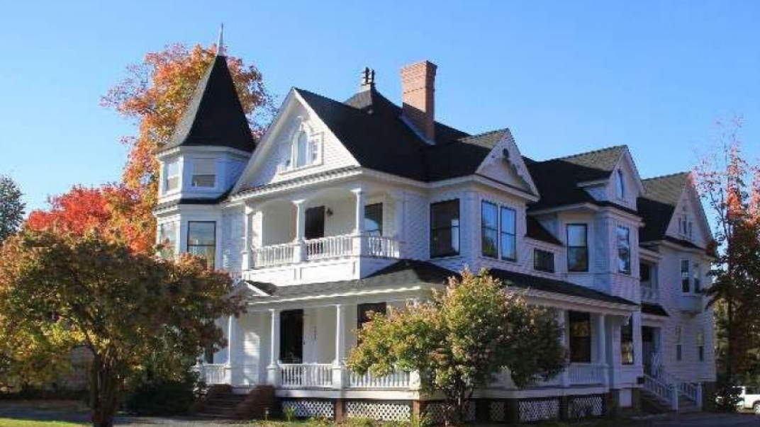 External shot of a white Victorian-style two-story house