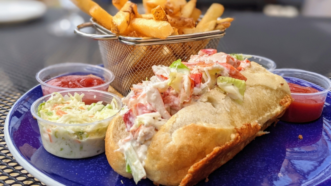 lobster roll with fries, coleslaw and a side of ketchup