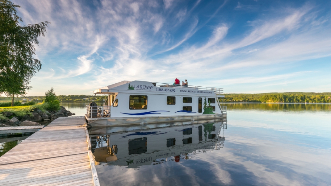 Docked houseboat by a lake