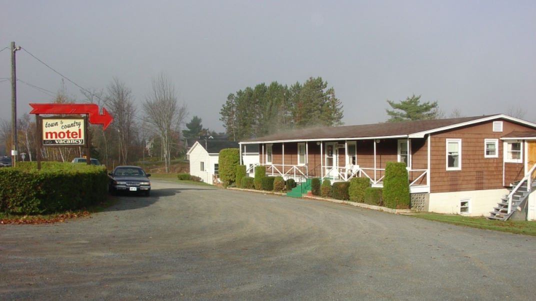 town and country motel with brown siding