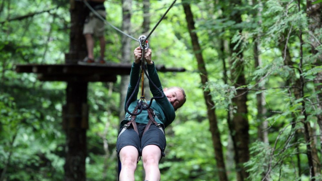 Person on zipline in forest