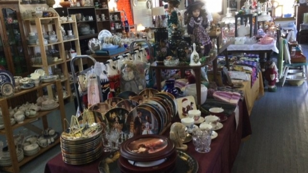 Assortment of vintage items displayed on table for sale