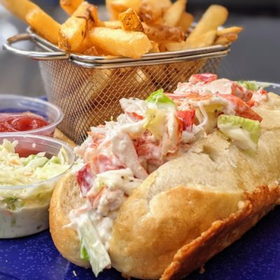 lobster roll with fries, coleslaw and a side of ketchup