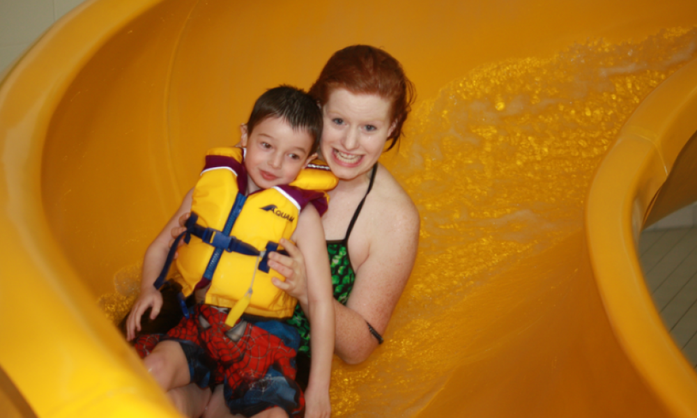 Woman and child going down waterslide