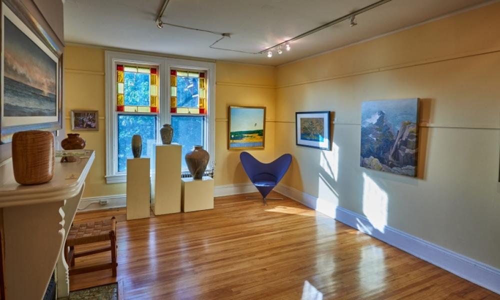 Gallery interior with paintings, pictures, and sculptures on display