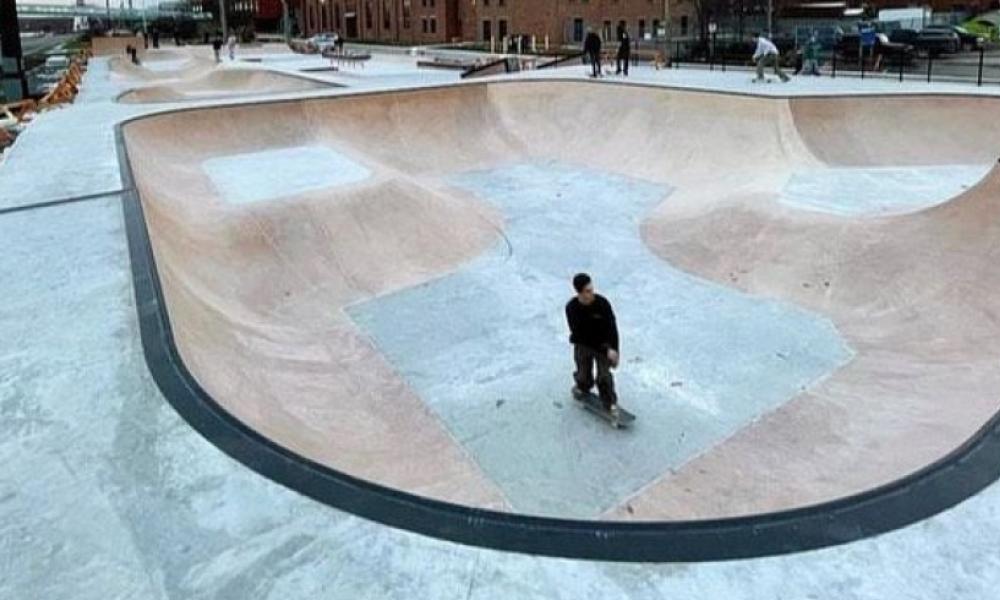Skateboarder skating inside skate park