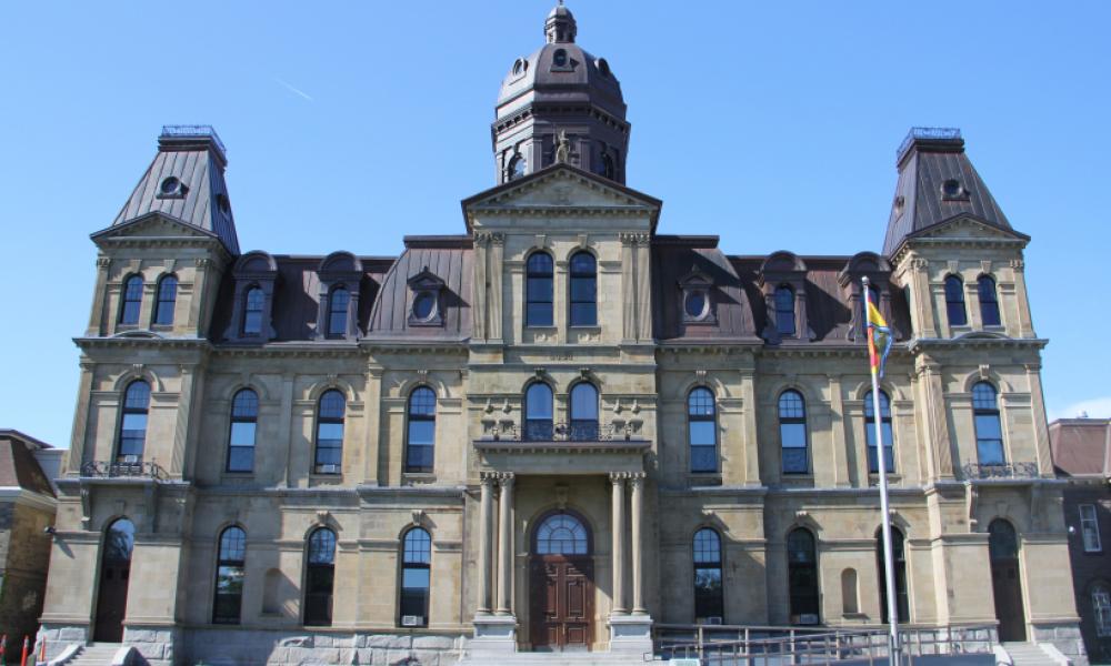 Exterior of legislative assembly building. The building is fashioned in Victorian architecture.