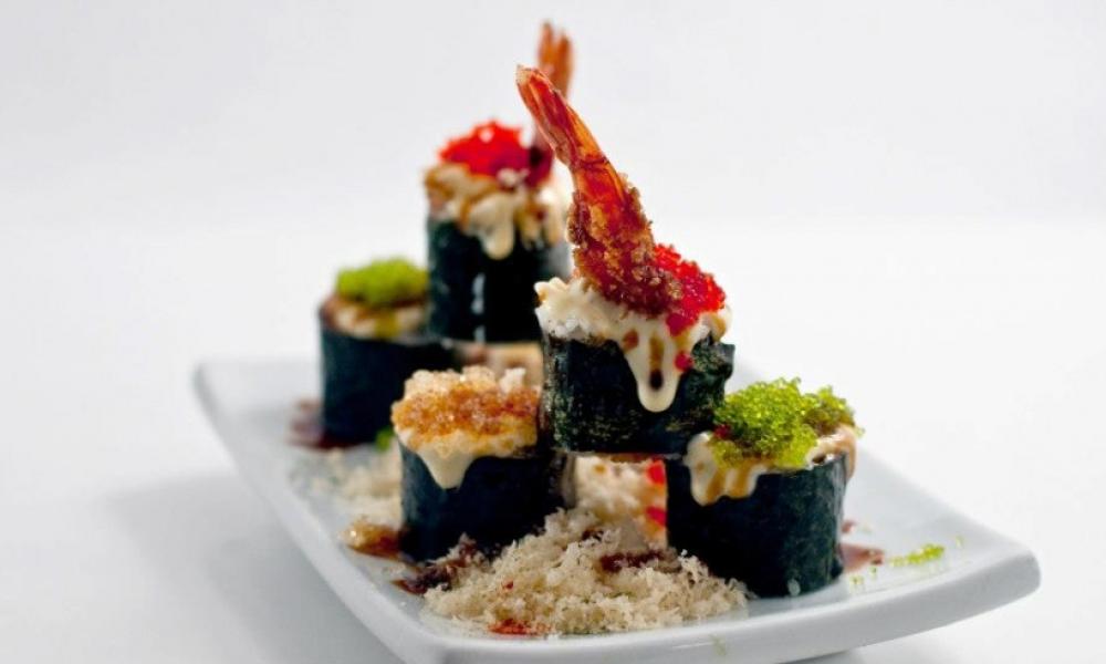 sushi stacked on a white plate