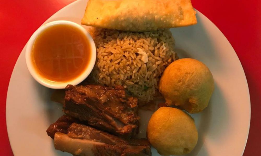 Chicken balls, ribs, rice, dumpling and sauce on a plate