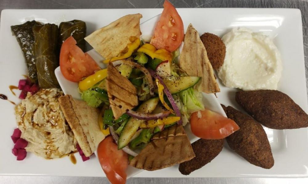 an appetizer plate with a dipping sauce