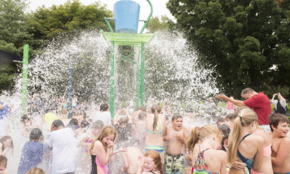 Children at waterpark getting splashed with water